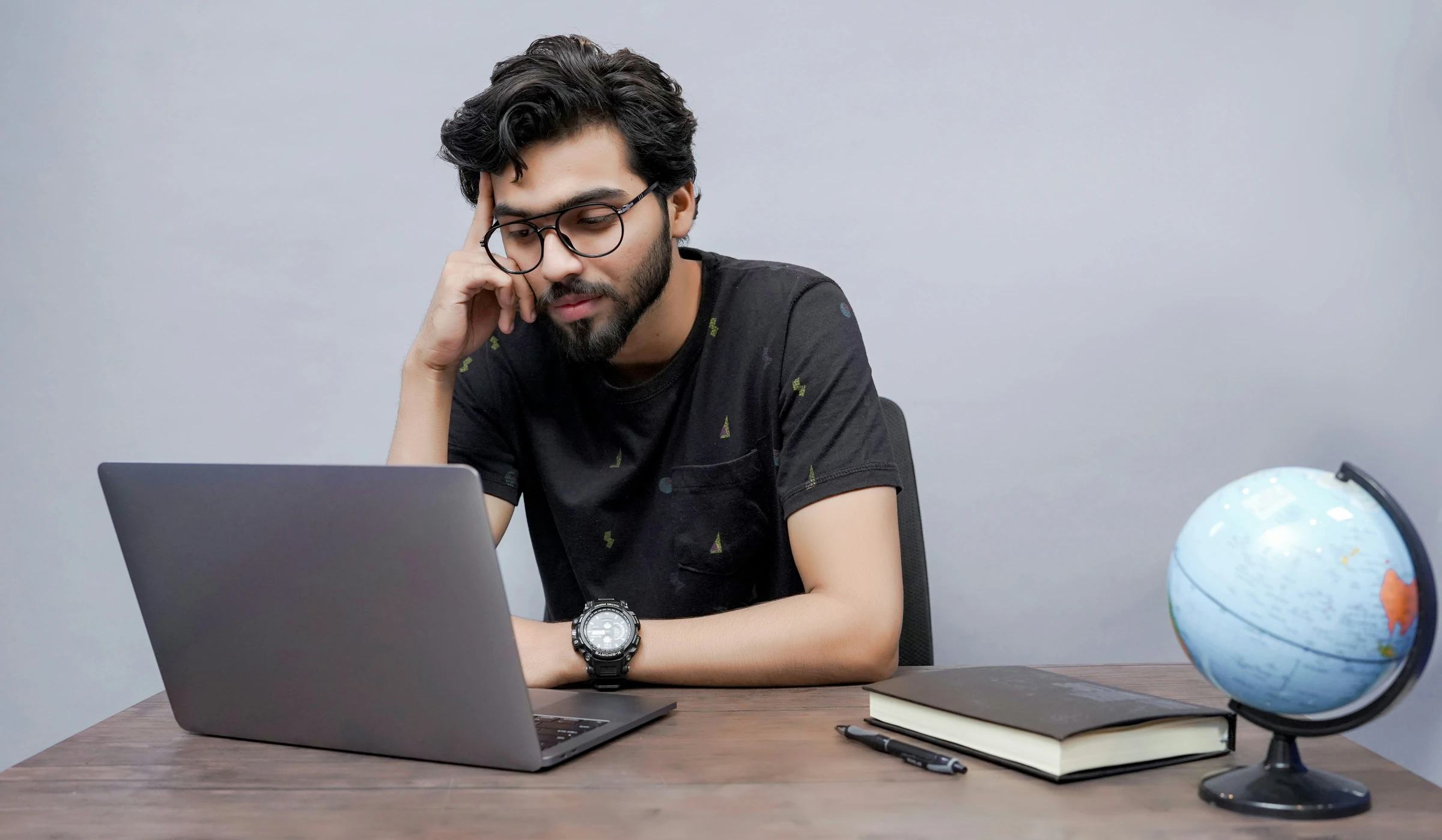 Student working on a college application on his laptop