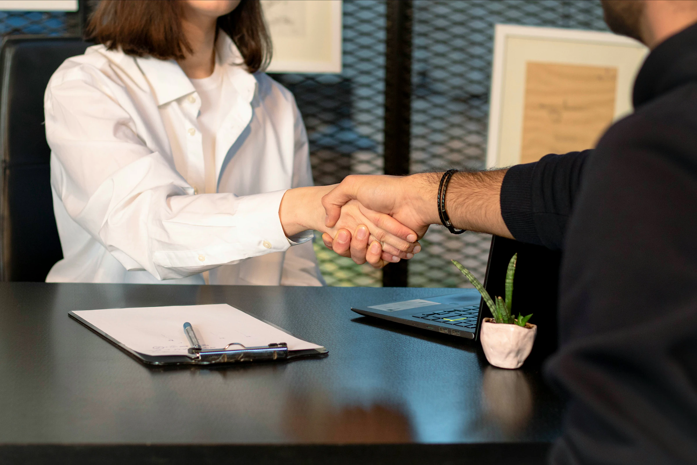 Business handshake across a desk