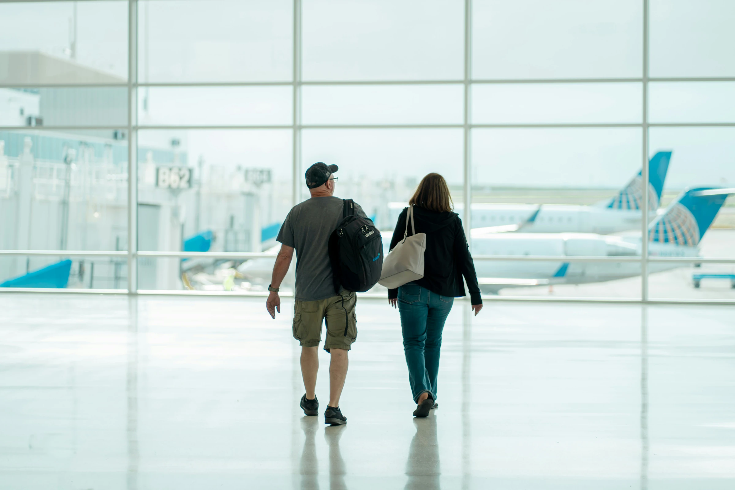 Couple walking through an airport terminal
